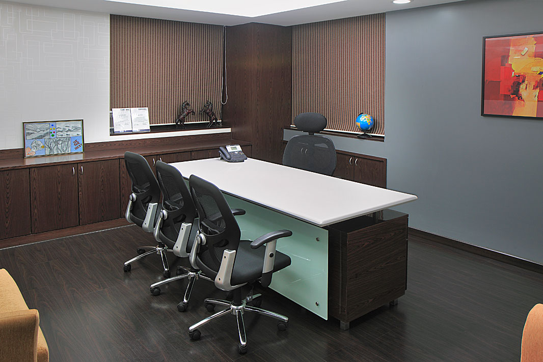 Furnished cabin with desk and chairs in the plug and play office for rent at The Capital, BKC
